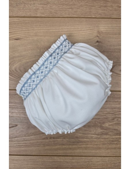 BRAGUITA VIELLA EN CRUDO BORDADA EN PUNTO SMOCK AZUL INGLÉS. ARTESANÍA CARMINA. INVIERNO 26.
